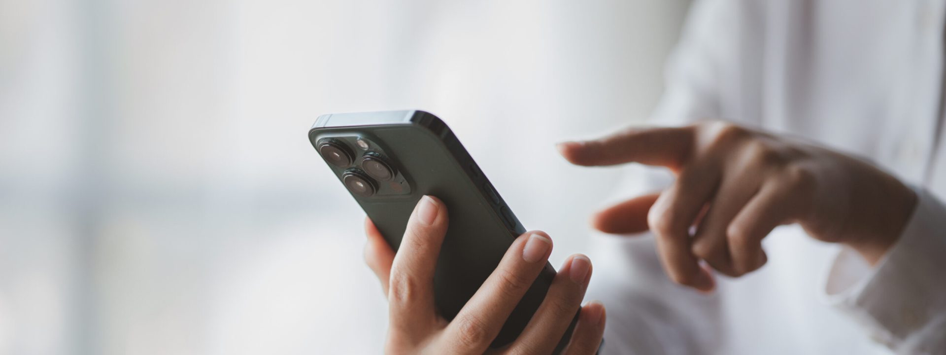 Business man looking at financial information from a mobile phone, he is checking company financial documents, he is an executive of a startup company. Concept of financial management.
